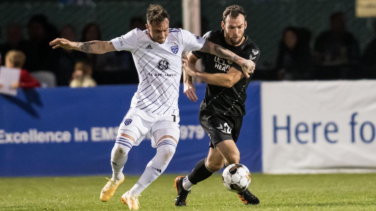 Sacramento Republic FC defender Conor Donovan, right, is called for a penalty challenging Louisville City FC forward Cameron Lancaster (17) on April 1 at Heart Health Park.