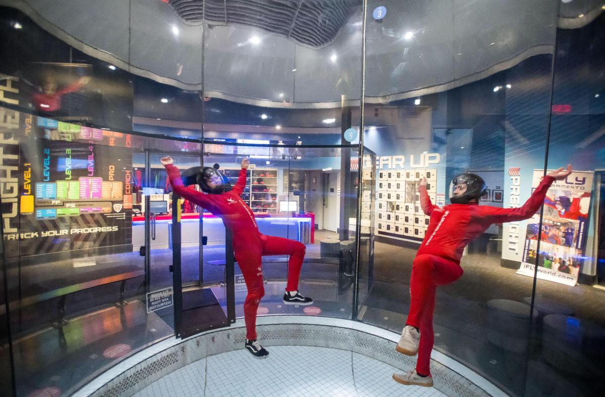 Lead instructor Richard Thai, left, and instructor Marcus DeWald demonstrate some tricks in tandem in the iFly Indoor Skydiving wind tunnel Sept. 20, 2023, in Roseville.