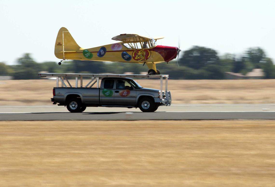 Kent Pietsch lands the Jelly Belly Barnstorming Place on a moving truck at the California Capital Airshow in 2012 at Mather Field in Rancho Cordova.