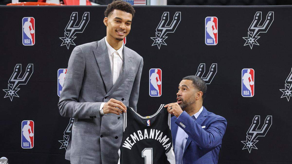 San Antonio Spurs draft pick Victor Wembanyama holds a jersey with general manager Brian Wright during a press conference at AT&T Center on June 24, 2023, in San Antonio, Texas.