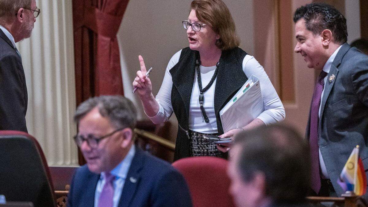 Senate President pro Tem Toni Atkins, D-San Diego speaks with Senator John Laird, D-Santa Cruz on Thursday, after they voted on the state budget at the Capitol.