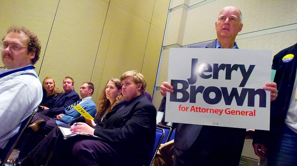 Attorney General candidate, Jerry Brown, holds his own support sign while touring the different caucus meetings at the California Democratic Convention, at the Sacramento Convention Center, Friday April 28, 2006. Sacramento Bee/ Brian Baer