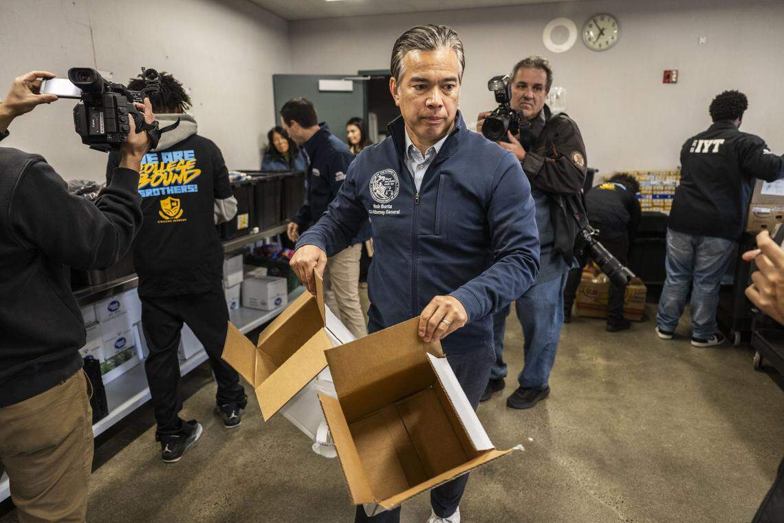 California Attorney General Rob Bonta helps recycle boxes as he helps organize a food pantry at Natomas High School with members of AmeriCorps and Improve Your Tomorrow on Tuesday.
