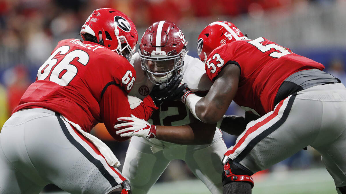 Alabama’s Quinnen Williams tries to split two offensive linemen during the SEC championship game Dec. 1 in Atlanta.