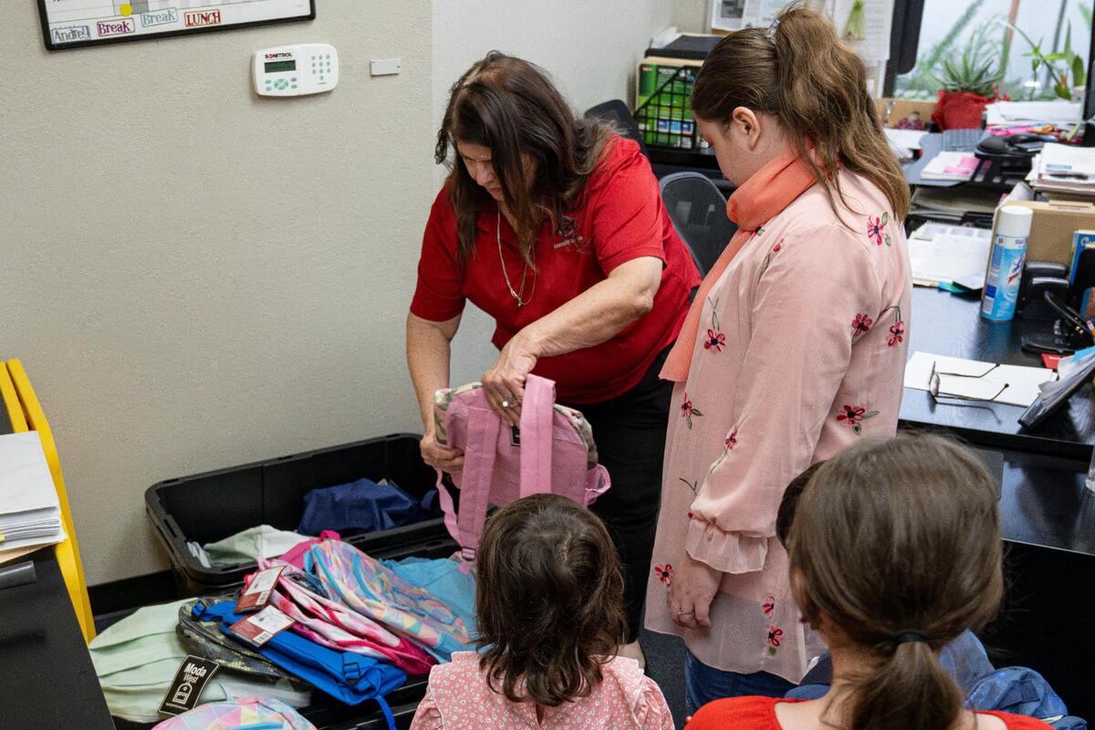 Cynthia Corral, center, distributes backpacks to refugee children at the Asian Resources Community Services offices Wednesday in Citrus Heights.