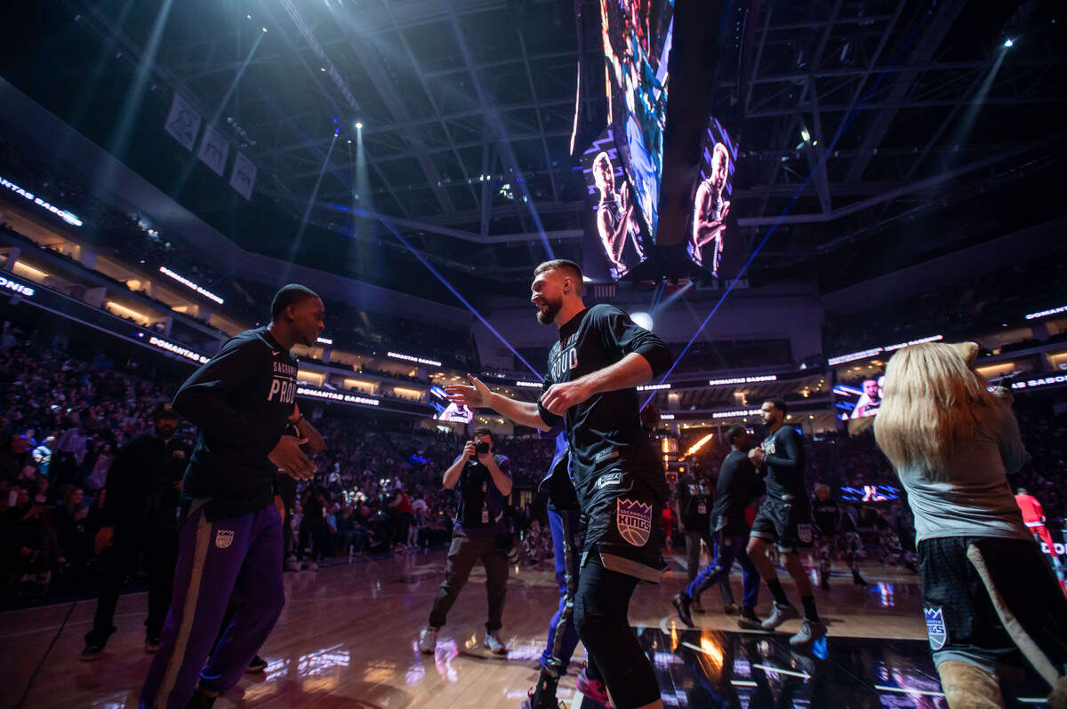 Sacramento Kings guard De’Aaron Fox (5), left, greets center Domantas Sabonis (10) to the floor after being announced before their NBA game against the Houston Rockets on Friday, Jan. 13, 2023, at Golden 1 Center in Sacramento.