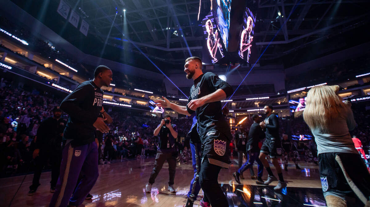 Sacramento Kings guard De’Aaron Fox (5), left, greets center Domantas Sabonis (10) to the floor after being announced before their NBA game against the Houston Rockets on Friday, Jan. 13, 2023, at Golden 1 Center in Sacramento.