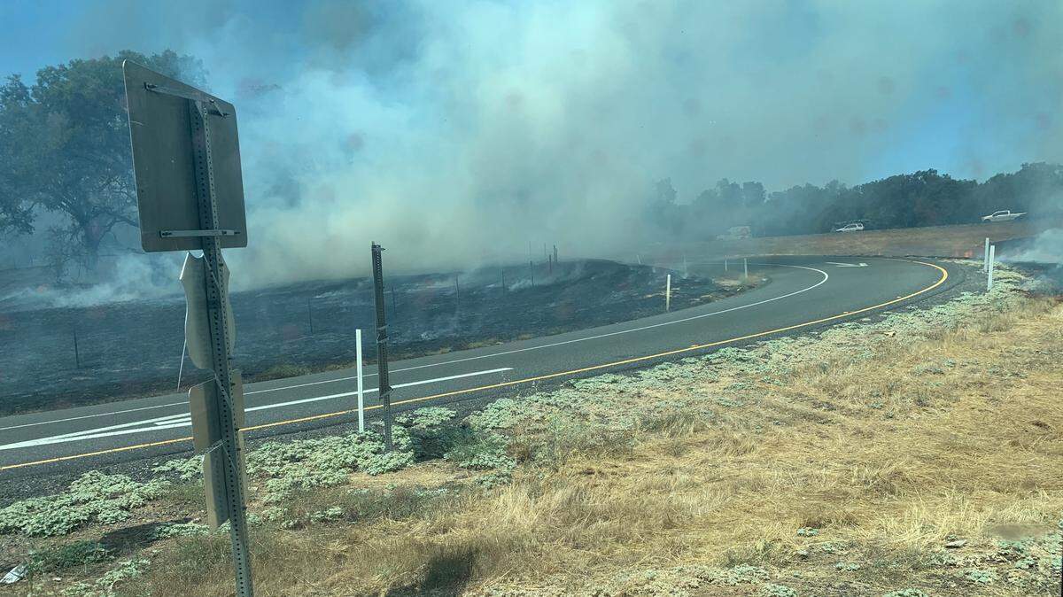 Grass burns near a Highway 50 off ramp Wednesday near Placerville.