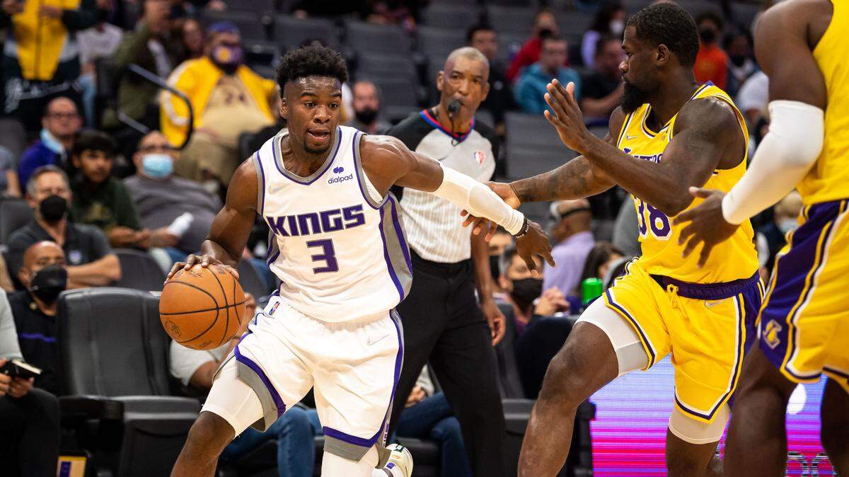 Sacramento Kings guard Terence Davis (3) dribbles around Los Angeles Lakers guard Chaundee Brown (38) in the fourth period of their final preseason NBA basketball game Thursday, Oct. 14, 2021, at Golden 1 Center in downtown Sacramento. The Kings beat the Lakers 116-112.