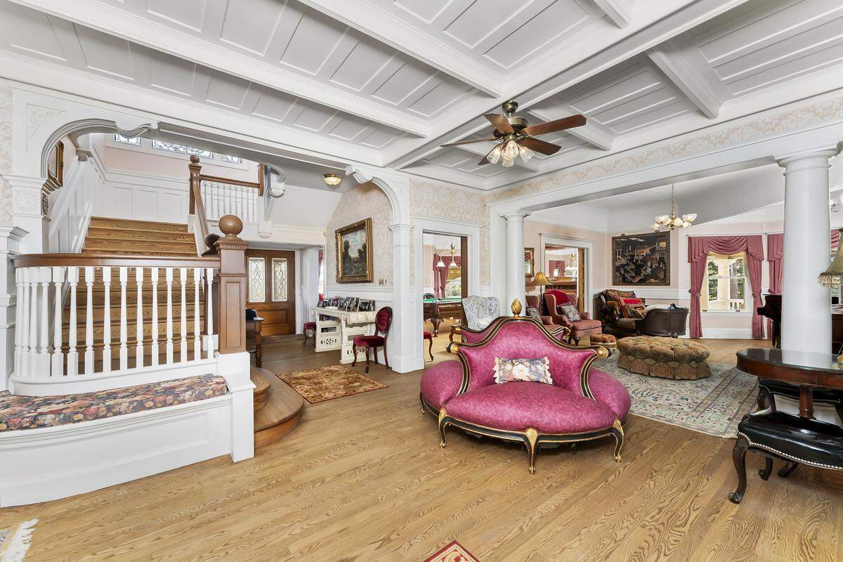 The stately entry and front living room set the tone for Hyholme’s approximately 6,000-square-foot, three-story layout, which includes seven bedrooms and five bathrooms arranged for both grand entertaining and everyday family living.