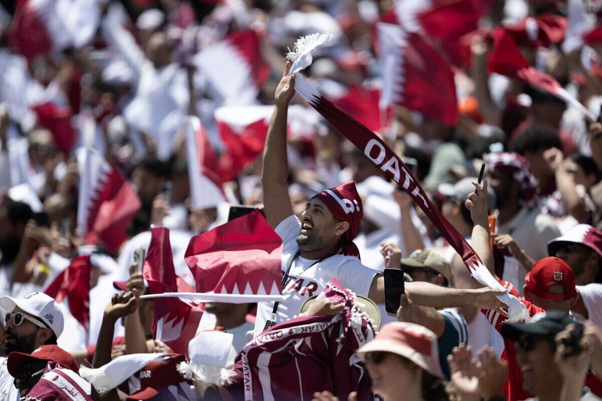 Qatar fans celebrate as the team scores in extra time against Switzerland to tie the game in the group stage of the 2026 World Cup on Saturday, June 13, 2026, in Santa Clara.