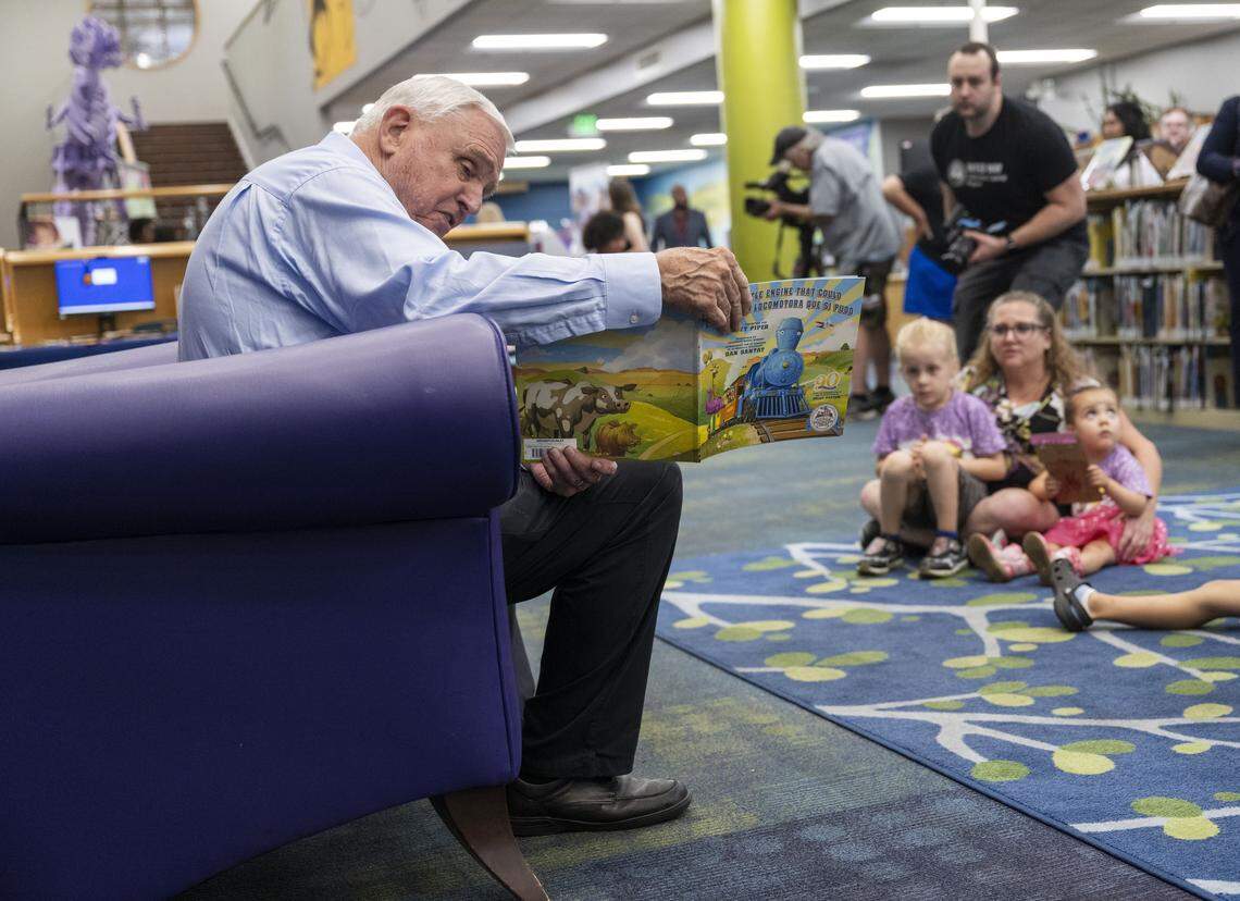 David W. Gordon, superintendent of the Sacramento County Office of Education, reads “The Little Engine that Could” to children during the launch of Dolly Parton’s Imagination Library in Sacramento County at the Sacramento Library on Wednesday. The program offers free books by mail to children in the county under age 5.