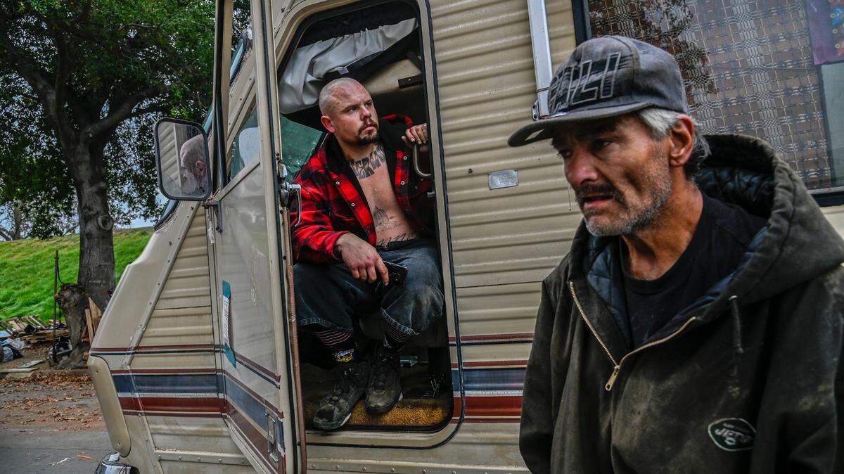 Dan Uyeda, right, was helping friends move including Shawn Stanner, left, as city crews clear vehicles and trailers along Lathrop Way on Monday, Dec. 6, 2021. “We are doing everything we can to just save his home,” said Uyeda.