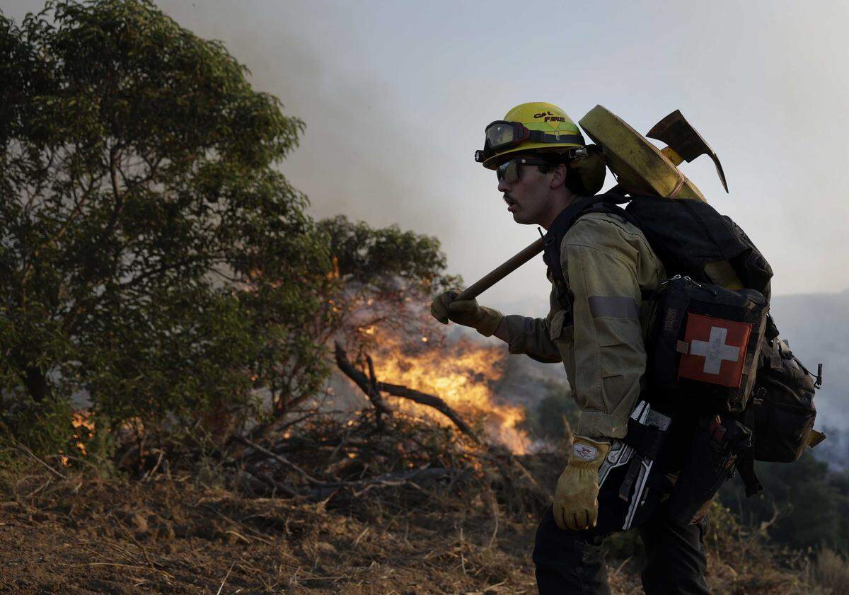 A Cal Fire firefighter battles the Sandy Fire on Monday, May 18, 2026, in Simi Valley. State officials say Northern California, including the Sacramento Valley, is forecast to enter above-normal fire risk by June as snowpack vanishes and drought spreads.