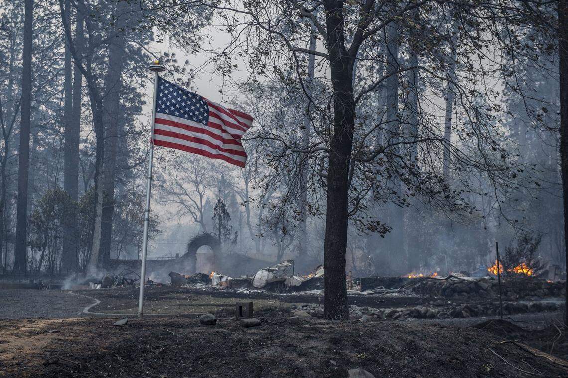 An American flag stands unburned at the corner of Pierson and Middle Libby Rd. in Paradise after the Camp Fire destroyed several homes in the area on Thursday, Nov. 8, 2018.
