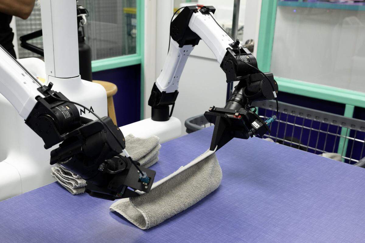 Sophy Swiftfold, a robotic folding system from Dyna Robotics, folds clothing at Monster Laundry on Friday in Sacramento. The AI-powered system can fold towels, linens and clothing.