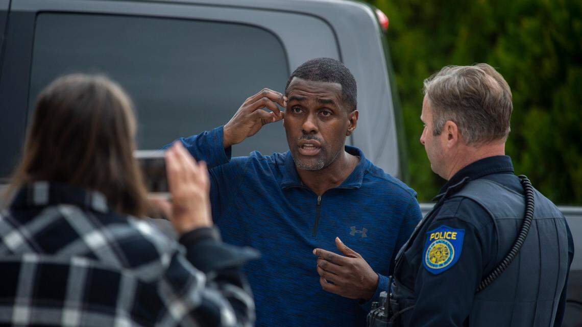 SEIU Local 1000 president Richard Louis Brown talks with a Sacramento police officer while a supporter records video of the conversation outside the union’s headquarters building Saturday, March 5, 2022. The police were called after Brown and his supporters gained access to the building as a maintenance employee was leaving earlier in the day.