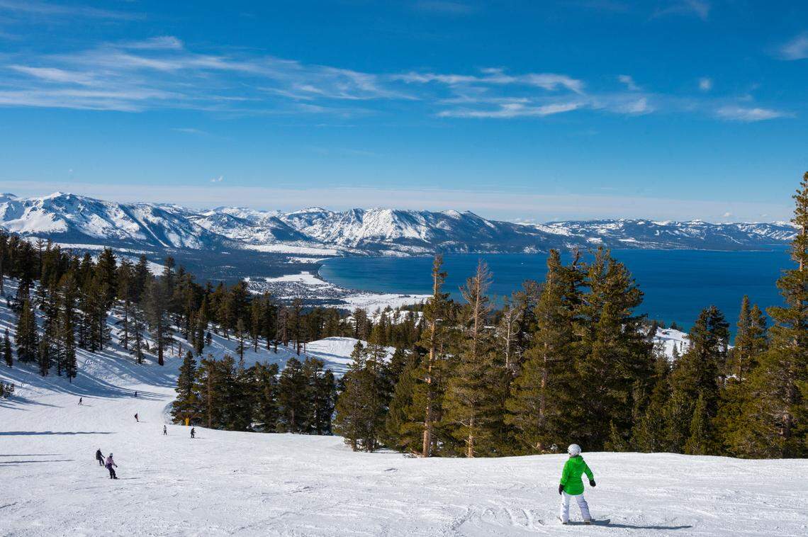 A snowboarder pauses to take in the views of Lake Tahoe from Heavenly Mountain Resort on Friday, Feb. 10, 2023.
