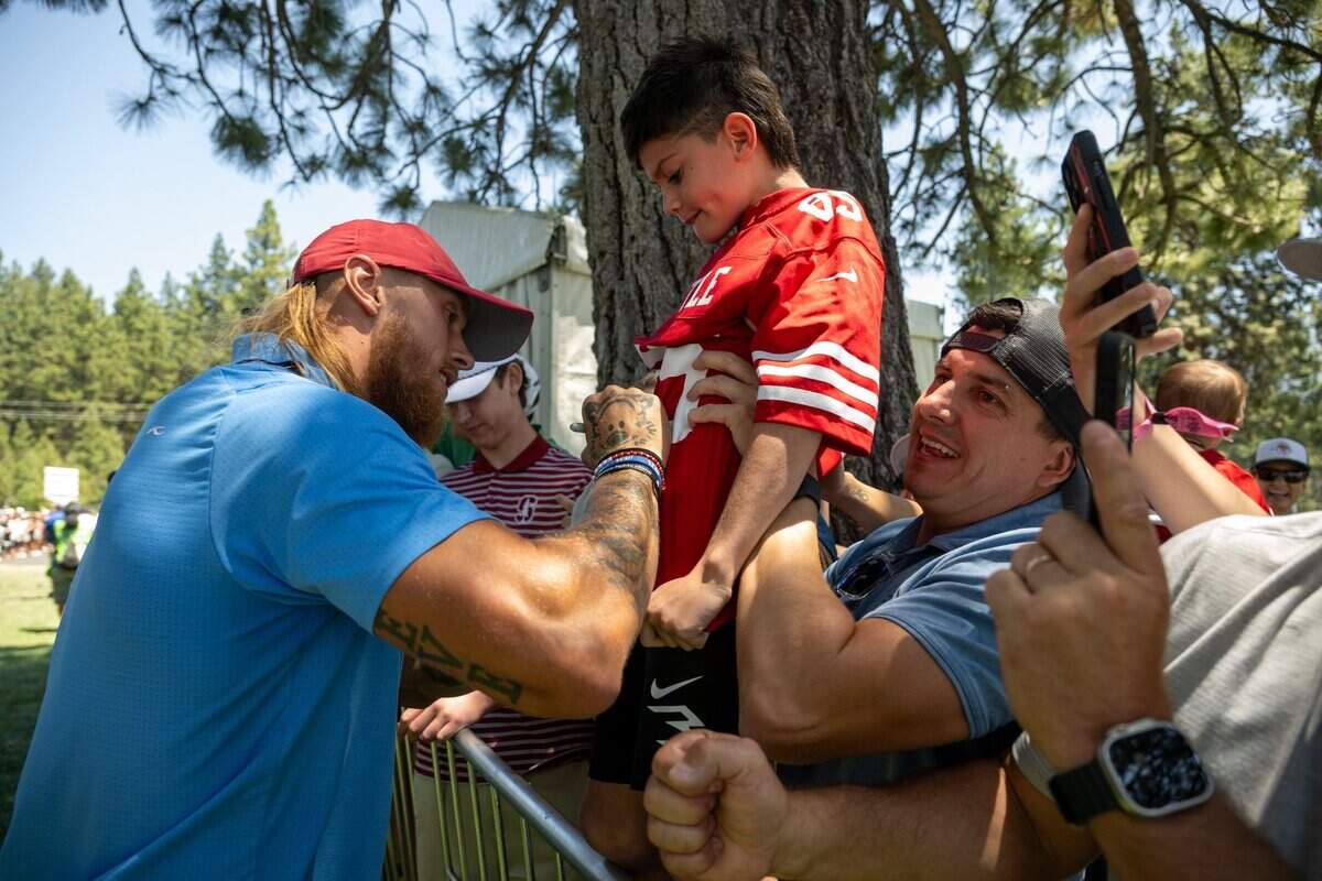 The San Francisco 49ers’ George Kittle signs his autograph on the jersey of Ikaia Gorman, 8, of Modesto, during the American Century Championship celebrity golf tournament at Edgewood Tahoe Resort in Stateline, Nev., on Friday, July 11, 2025.