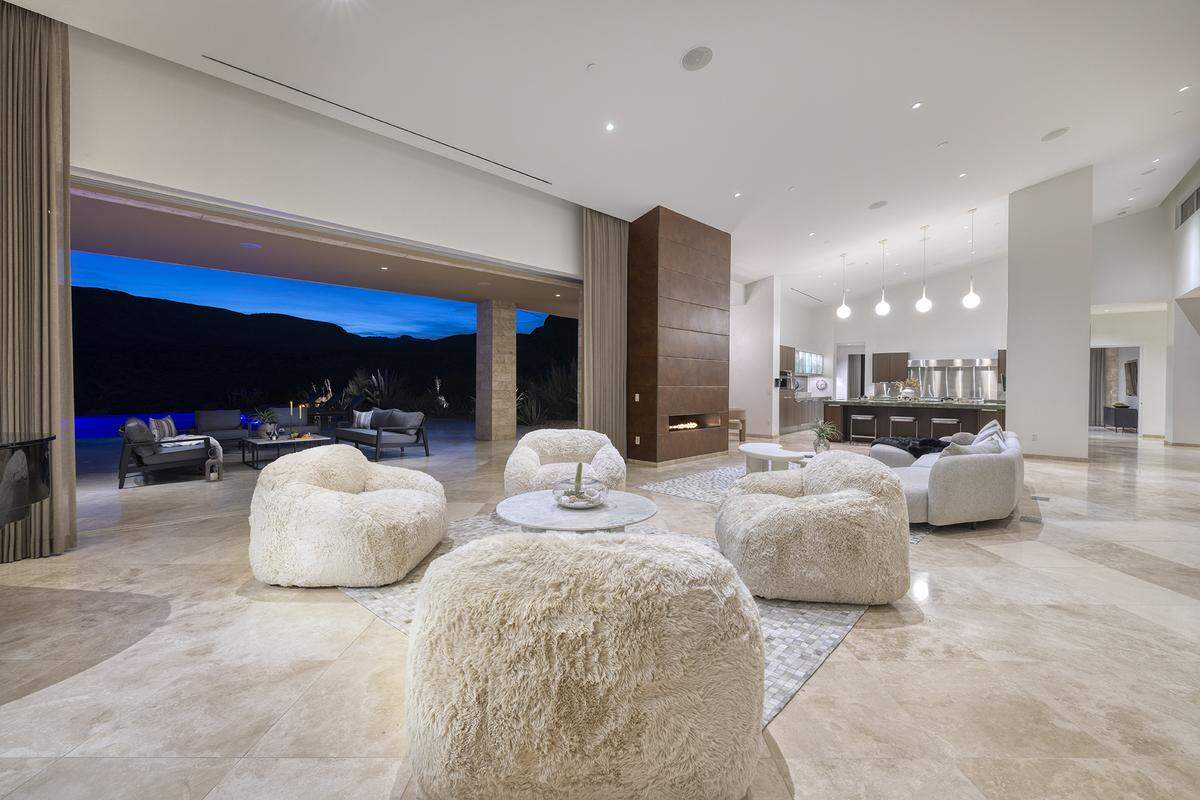 The roughly 9,887-square-foot home includes seven bedrooms, nine bathrooms, a glass-enclosed wine display, multiple entertaining bars and indoor-outdoor dining areas.