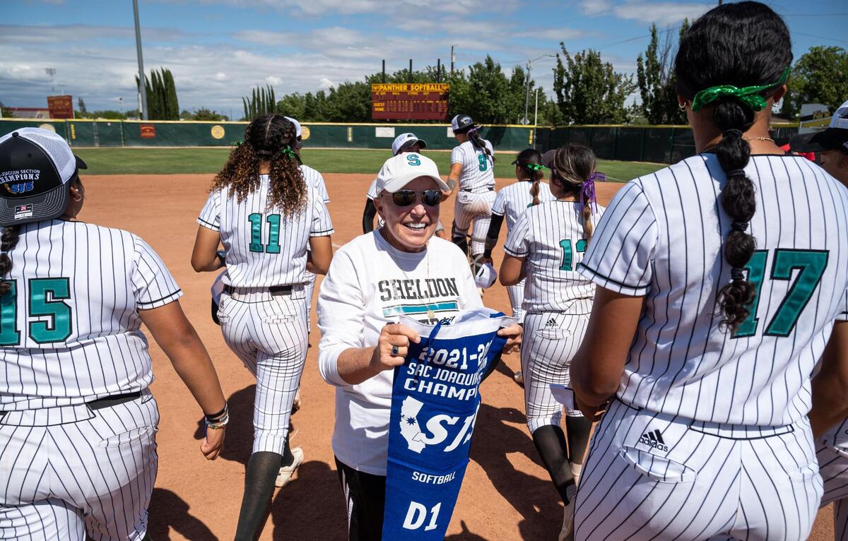 Sheldon High School head softball coach Mary Jo Truesdale holds the team’s pennant after defeating Lincoln of Stockton7-1 for the CIF Sac-Joaquin Section Division I title Saturday at Sacramento City College.
