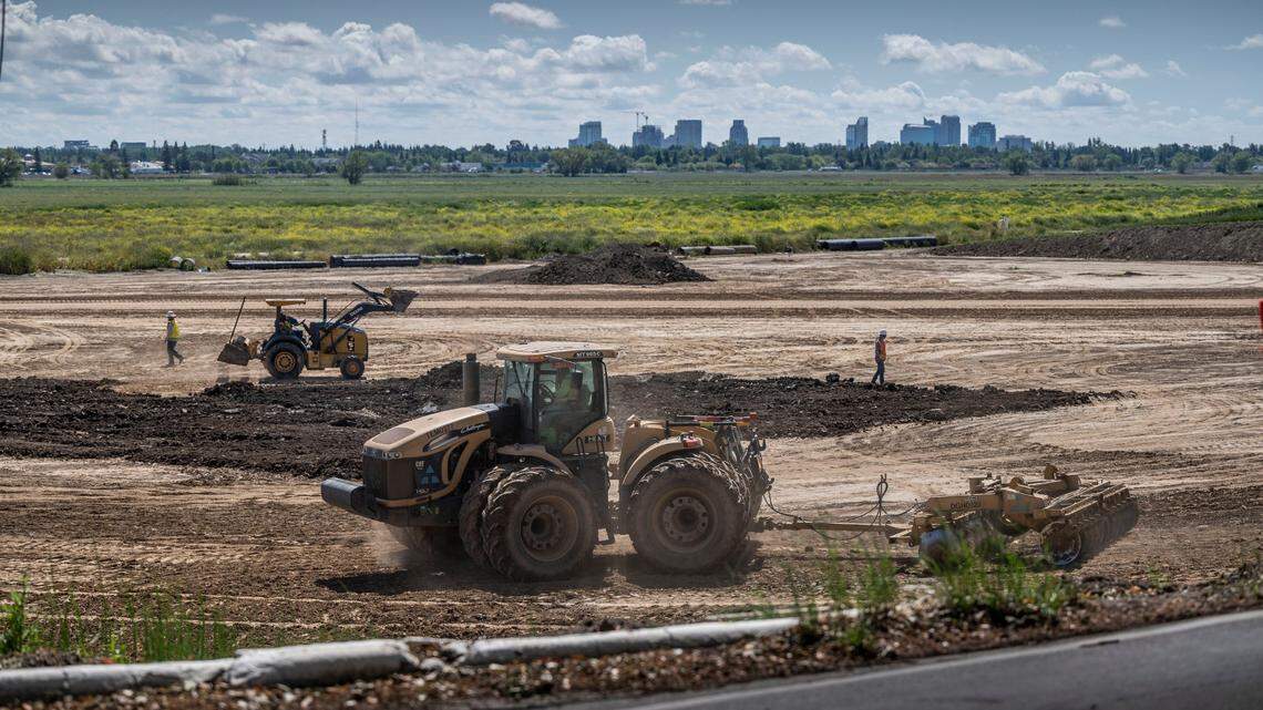 Construction vehicles move dirt near a levee in Natomas in April. The Sacramento region stands to gain millions of dollars for transportation, environmental and job-training projects through congressional earmarks in the $1.7 trillion federal budget that Congress is expected to pass this week.