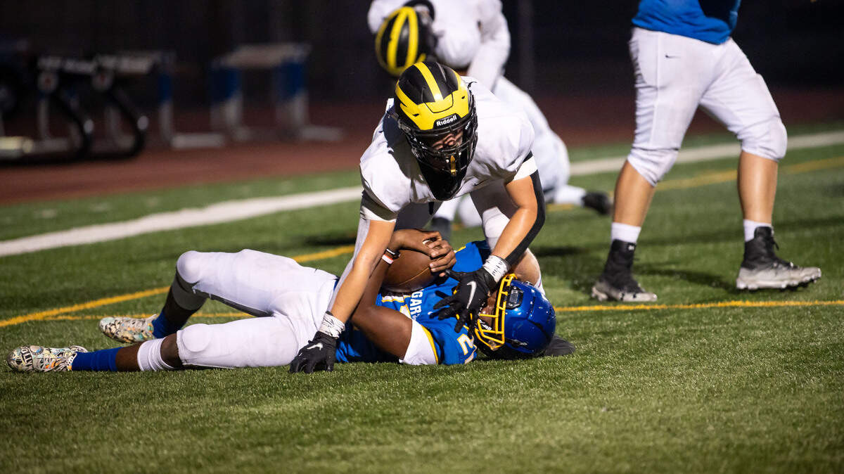 Del Oro’s Jimmy Brear pushes himself up after sacking Del Campo’s Richard Johnson for a safety in the second quarter of the high school football game Friday, Aug. 27, 2021, at Del Campo High School in Fair Oaks.