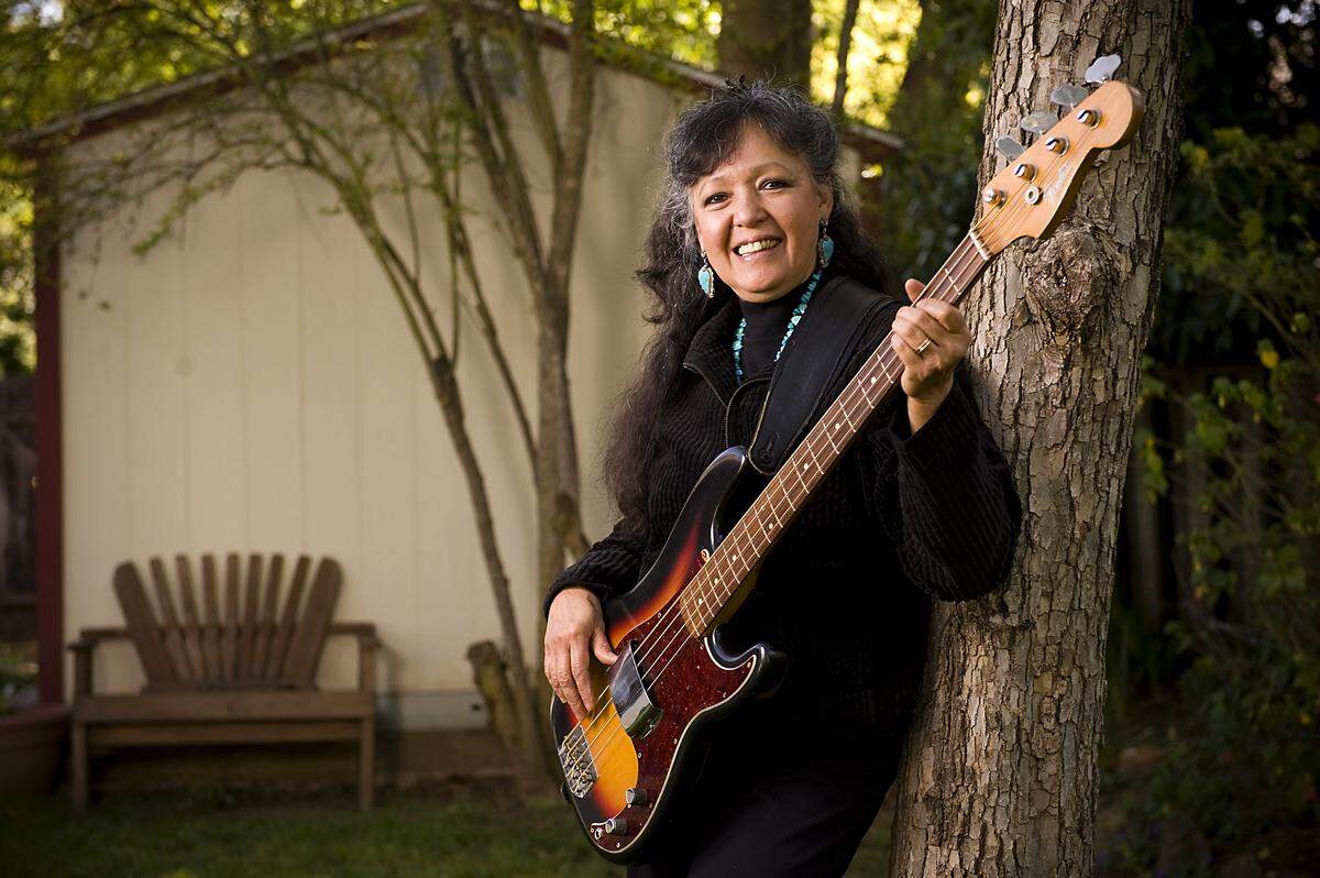 Jean Adamian holds her Fender Precision bass guitar at her Davis home in 2010. As Jean Millington, she and her sister June Millington started the band Fanny after playing high school events around Sacramento as The Svelts in the 1960s. Adamian suffered a stroke in recent years and hasn’t regained the ability to play the bass.