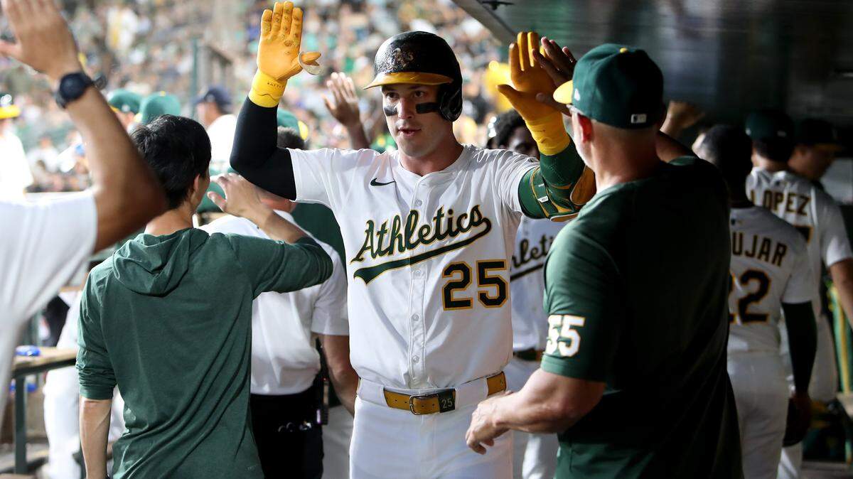 Jul 12, 2025; West Sacramento, California, USA; Athletics designated hitter Brent Rooker (25) celebrates with teammates after hitting a two run home run against the Toronto Blue Jays during the fifth inning at Sutter Health Park. Mandatory Credit: Dennis Lee-Imagn Images