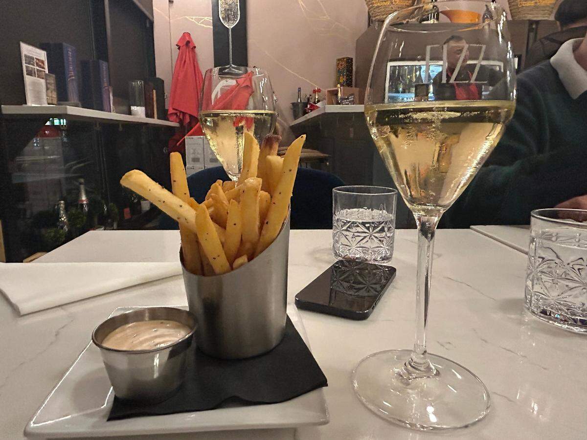  A glass of French Sparkling Blanc de Blanc of the happy hour menu for $10 and an order of duck fat fries for $8 at Fizz Champagne and Bubbles Bar.