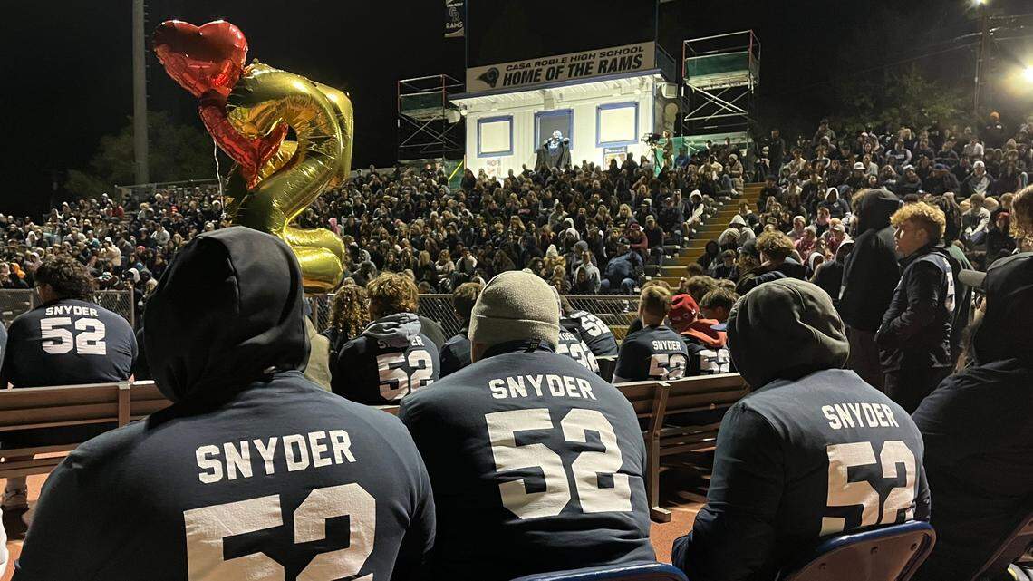 Loved ones and community members gather Monday at Casa Roble High School in Orangevale for a vigil for senior football player Julian Snyder, who died Friday in a vehicle crash in Roseville.
