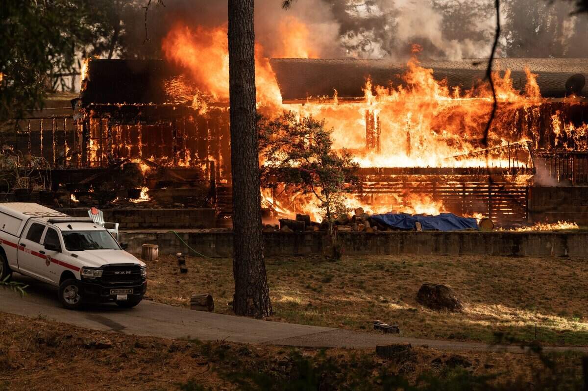 A fully involved house burns on the 16000 block of Mount Olive Road during the River Fire on Wednesday, Aug. 4, 2021, in Nevada County.