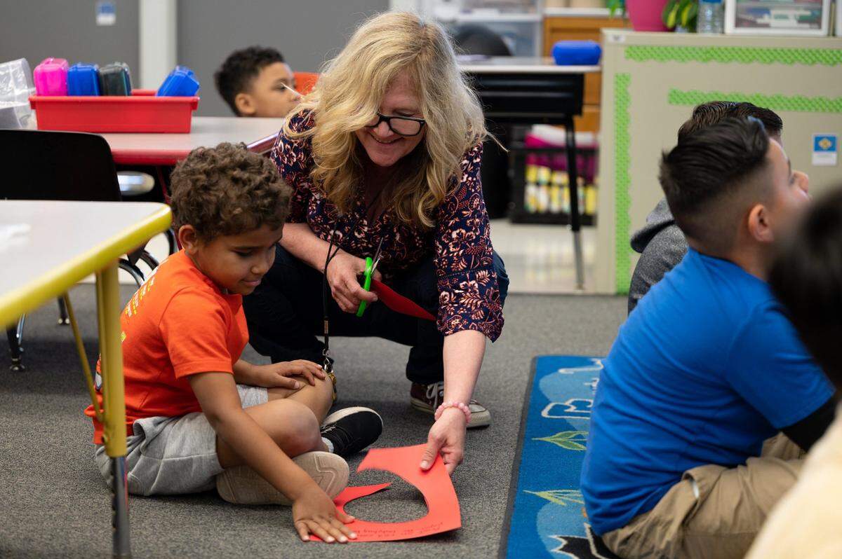 Teacher Kirstin Harding helps student Elijah Upshaw, 6, on Monday in the afternoon kindergarten class she co-teaches with Beverly Bair at Peter J. Shields Elementary School in Rancho Cordova. The school will switch to full-day kindergarten next year.