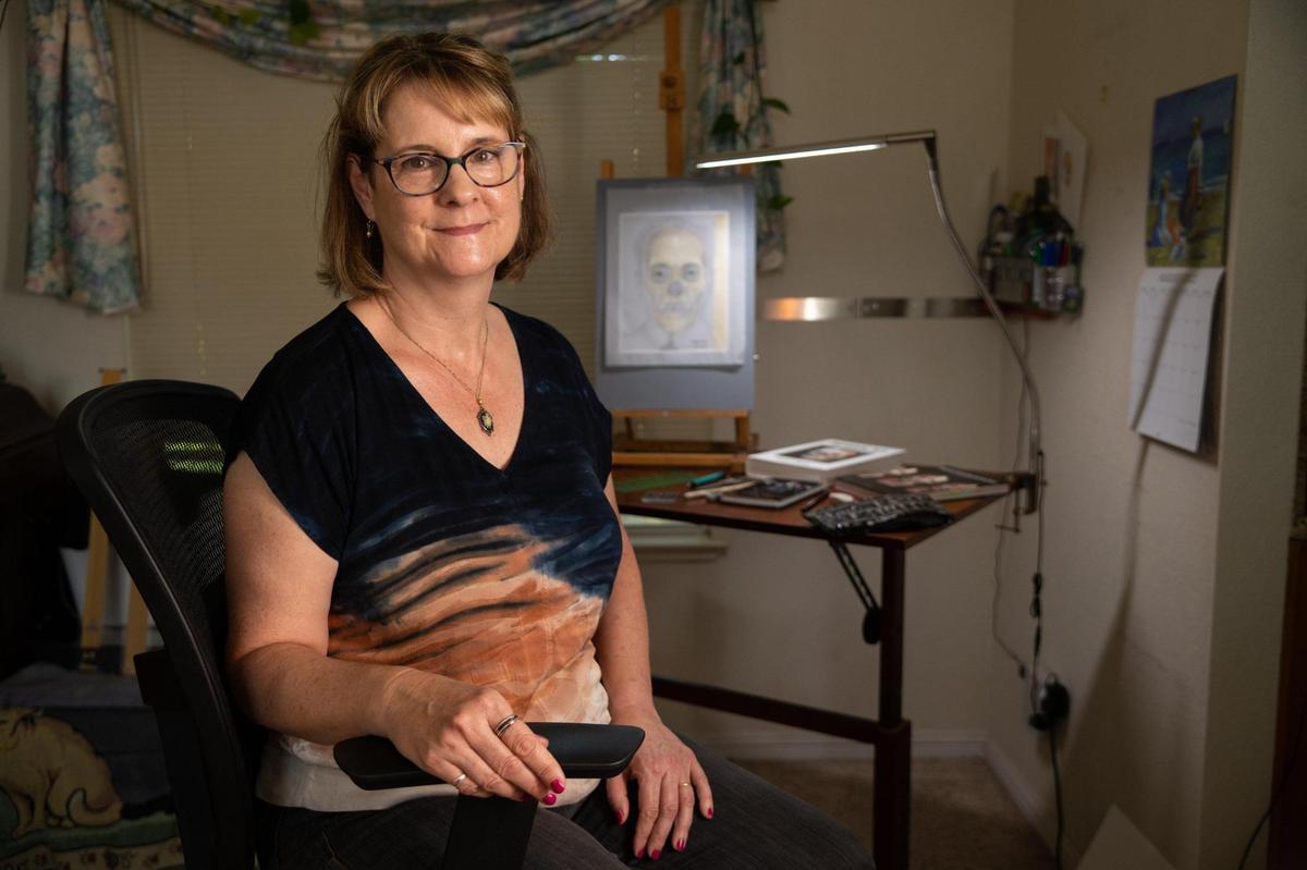Forensic sketch artist Barbara Anderson sits near one of her facial reconstruction sketches at her home in Rocklin on Wednesday, Aug. 3, 2022. Forensic sketch artists put a face to the nameless and can help bring closure to the families that are looking for them. She begins the process of sketching an unidentified body using the skull.
