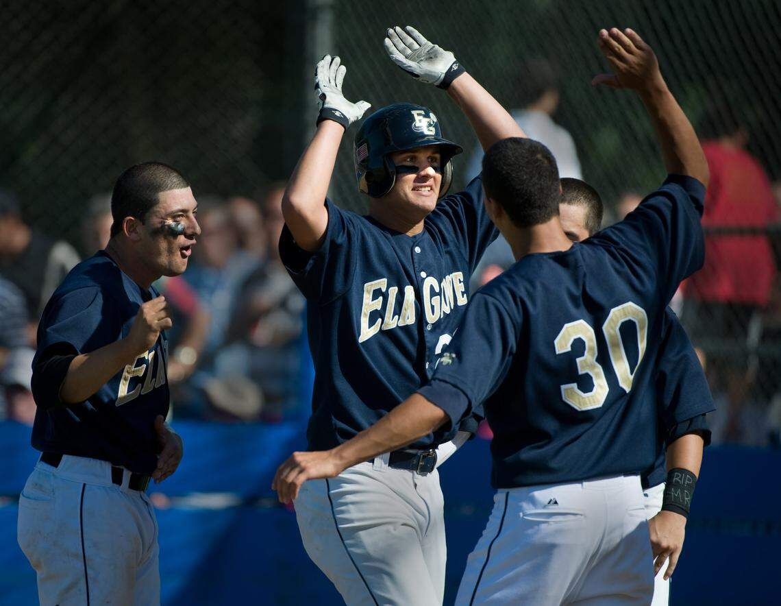 Elk Grove’s J.D. Davis celebrates with some high fives after hitting a second home run during the first game of a Division I Sac-Joaquin Section North championship doubleheader against Jesuit at American River College in 2010. Elk Grove won 4-1, 11-0.