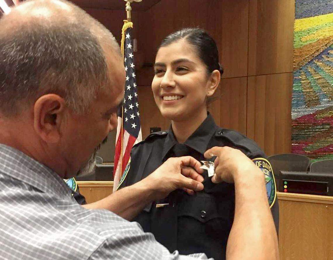 Merced Corona, left, pins his daughter Natalie Corona’s badge on her uniform during a swearing-in ceremony in Davis on Aug. 2, 2018. Davis Police will hold a remembrance ceremony for Corona, who was shot and killed during a routine call Thursday, Jan. 10, 2019.