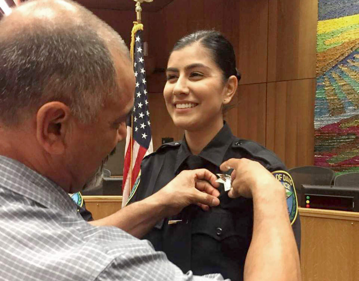 Merced Corona, left, pins his daughter Natalie Corona’s badge on her uniform during a swearing-in ceremony in Davis on Aug. 2, 2018. Davis Police will hold a remembrance ceremony for Corona, who was shot and killed during a routine call Thursday, Jan. 10, 2019.