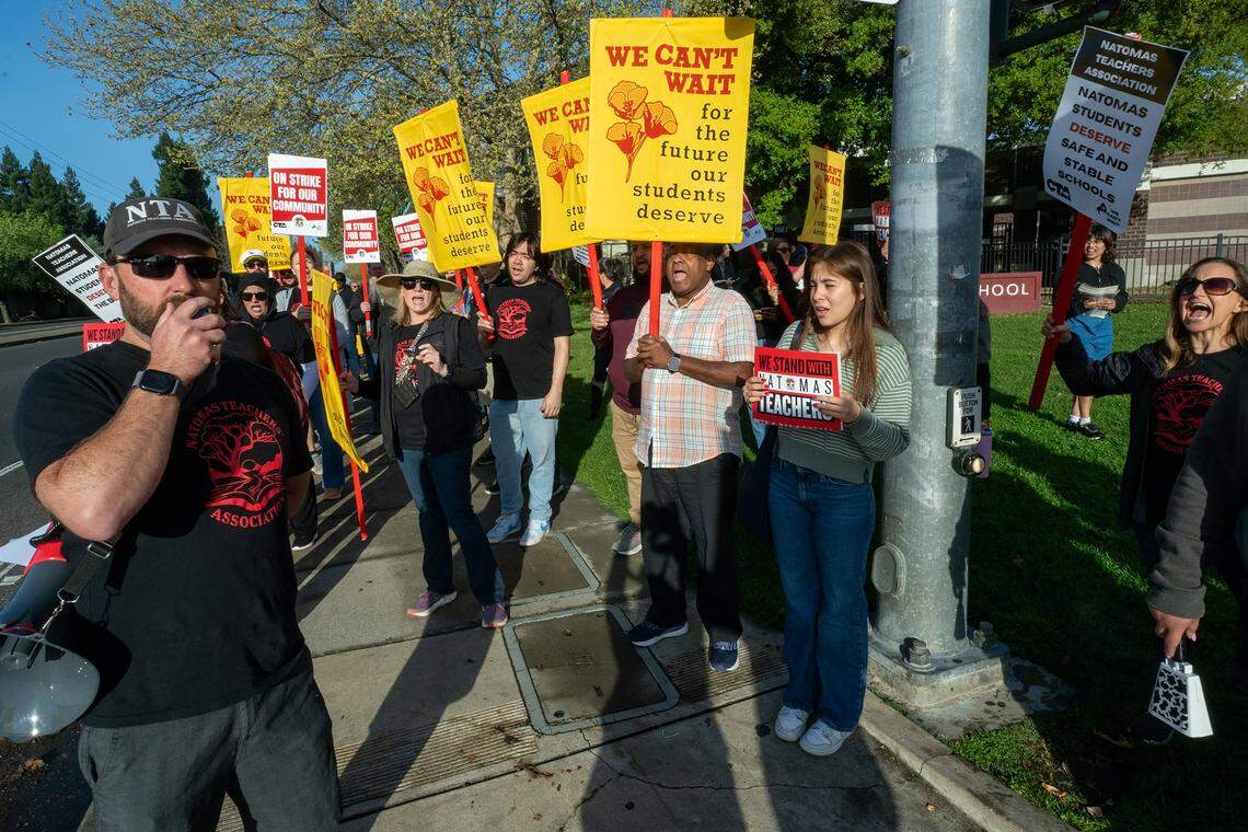 Jeff Bryan, an English teacher at Natomas High School, leads a chant with strikers Tuesday in front of the Sacramento school on the first day of the first strike in the school district's history.