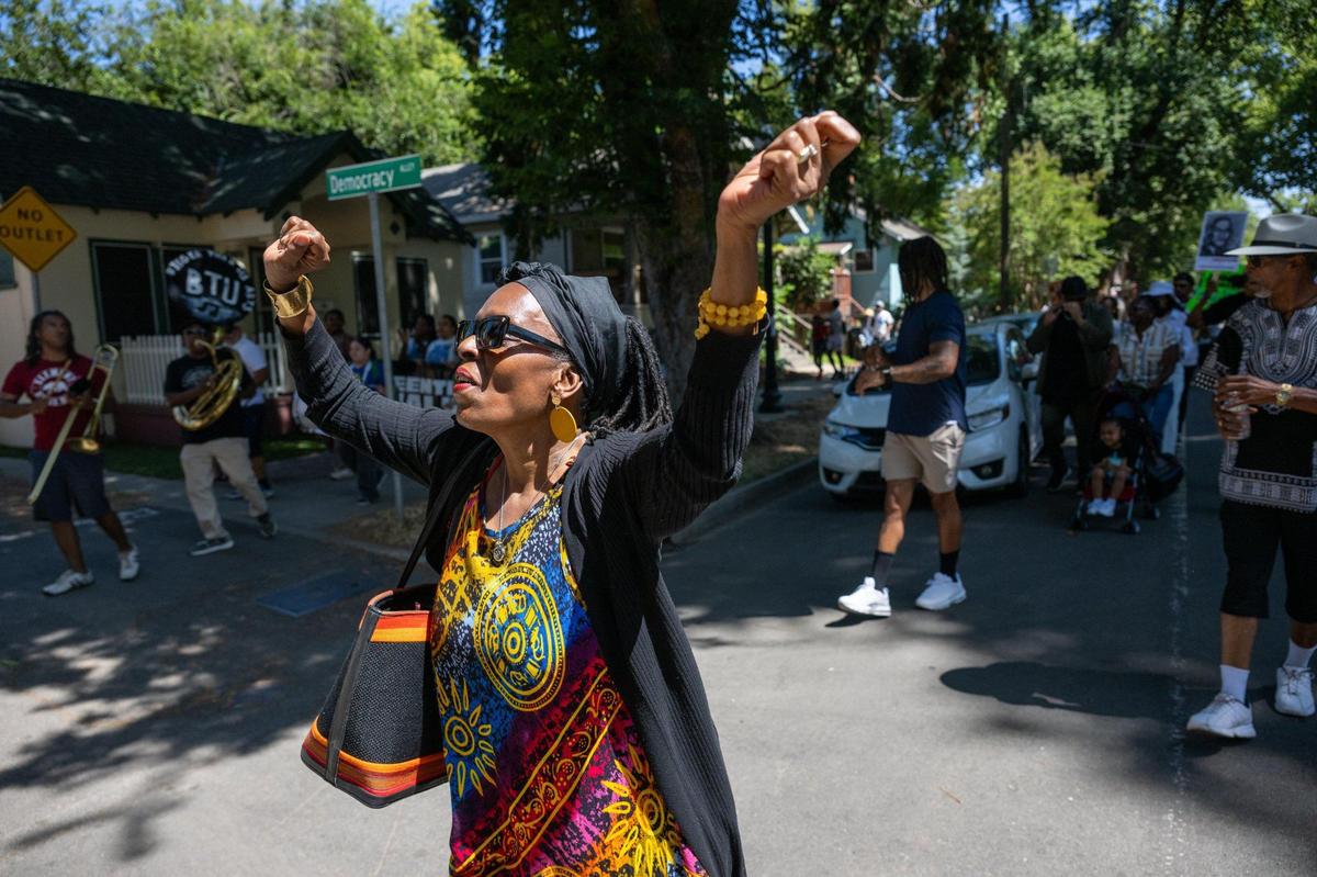 Anya Jaleane dances to the music of the New Orleans-style Element Brass Band as the group parades to the Capital Stage of the during the second annual Juneteenth Art Walk on Thursday in Sacramento.