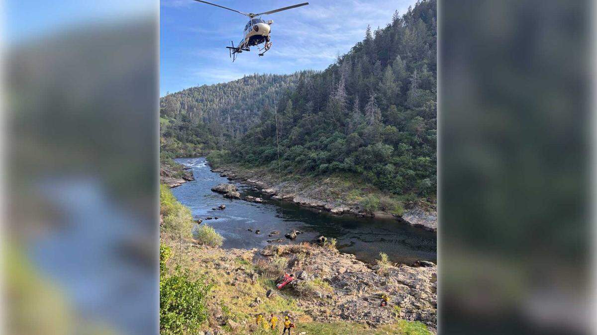 A California Highway Patrol helicopter hoists an injured hiker in a rescue basket from the shoreline of the South Fork of the American River near Coloma, Calif., on Sunday, March 29, 2026. The hiker fell about 30 feet down a steep embankment after hiking roughly a mile into a remote canyon, prompting a multi-agency rescue involving El Dorado County sheriff’s deputies, Cal Fire and local fire personnel.