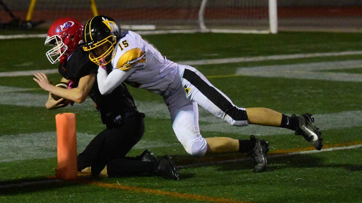 Mira Loma quarterback Deangelo Keys (6) slides into the end zone for a touchdown against Delta defender Royce Cornelson in their CIF Sac-Joaquin Division VIII semifinal game Friday at El Camino High School in Arden Arcade. Keys and the top-seeded Matadors defeated the Saints, 48-34.
