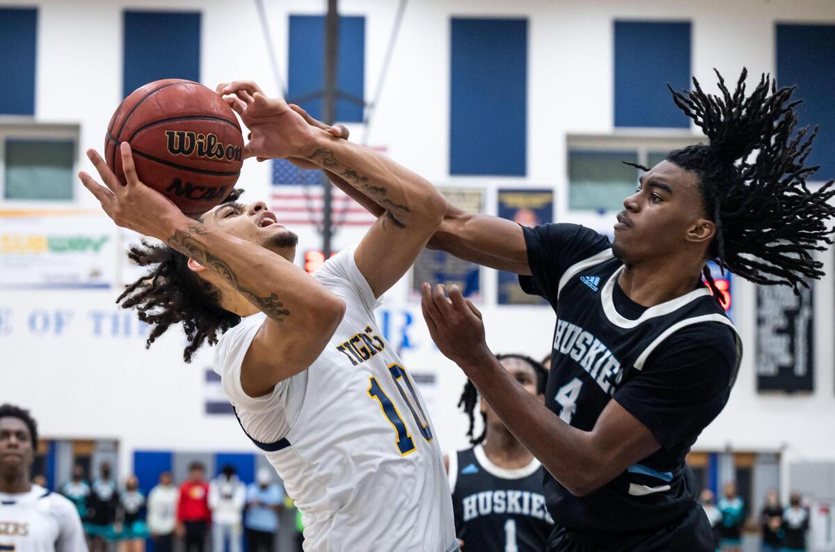 Inderkum Tigers’ Derrick Claxton (10), left, tries to get a shot off as Sheldon Huskies’ Rashaud Bradley (4) defends during the third period at the high school boys basketball Sac-Joaquin Section Division I semifinal playoff game Wednesday, Feb. 23, 2022, at Inderkum High School in Sacramento. Sheldon beat Inderkum, 85-80, to advance to the title game.