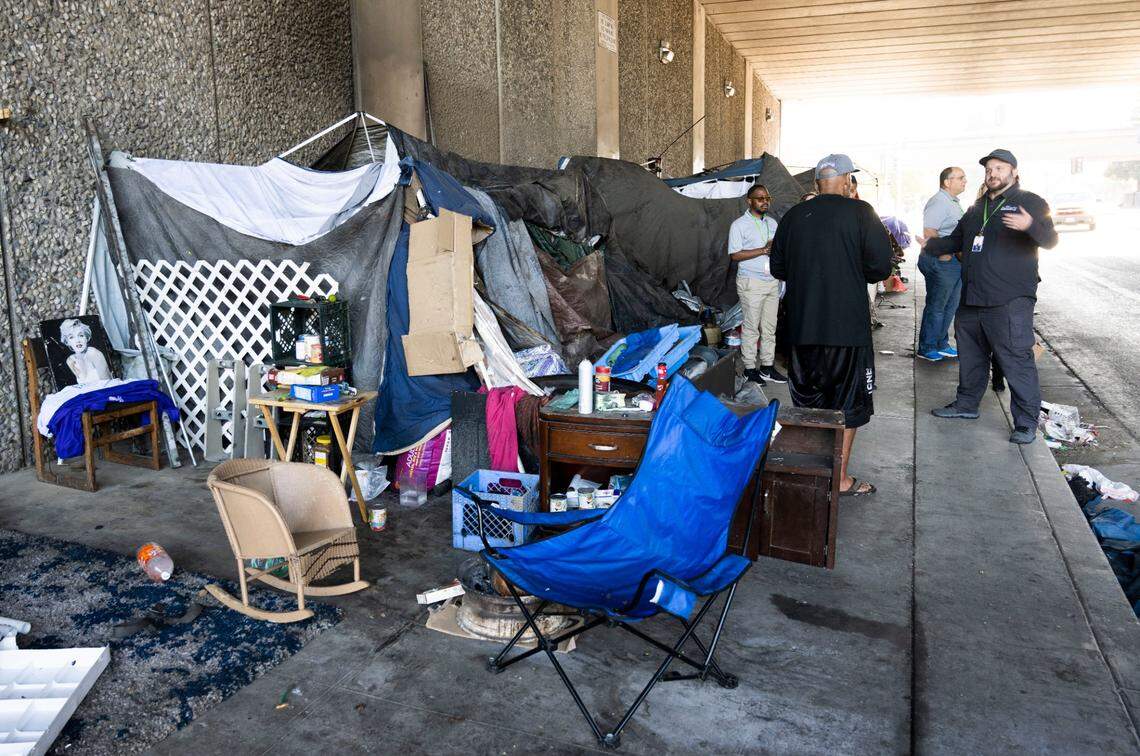 Members of the Sacramento Community Response team inform campers on Broadway earlier this month about a new city ordinance that requires a four-foot clearance on sidewalks for wheelchair access.