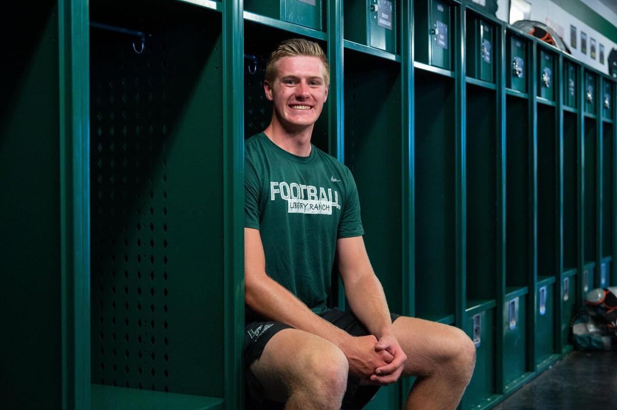 Liberty Ranch Hawk tight end Cody Smith sits in his locker in Galt, Wednesday, July 20, 2022. At 6-foot-7, Cody Smith, who has had a couple of seasons cut short by injuries is looking to make a big impact on the local sports scene before going to college.