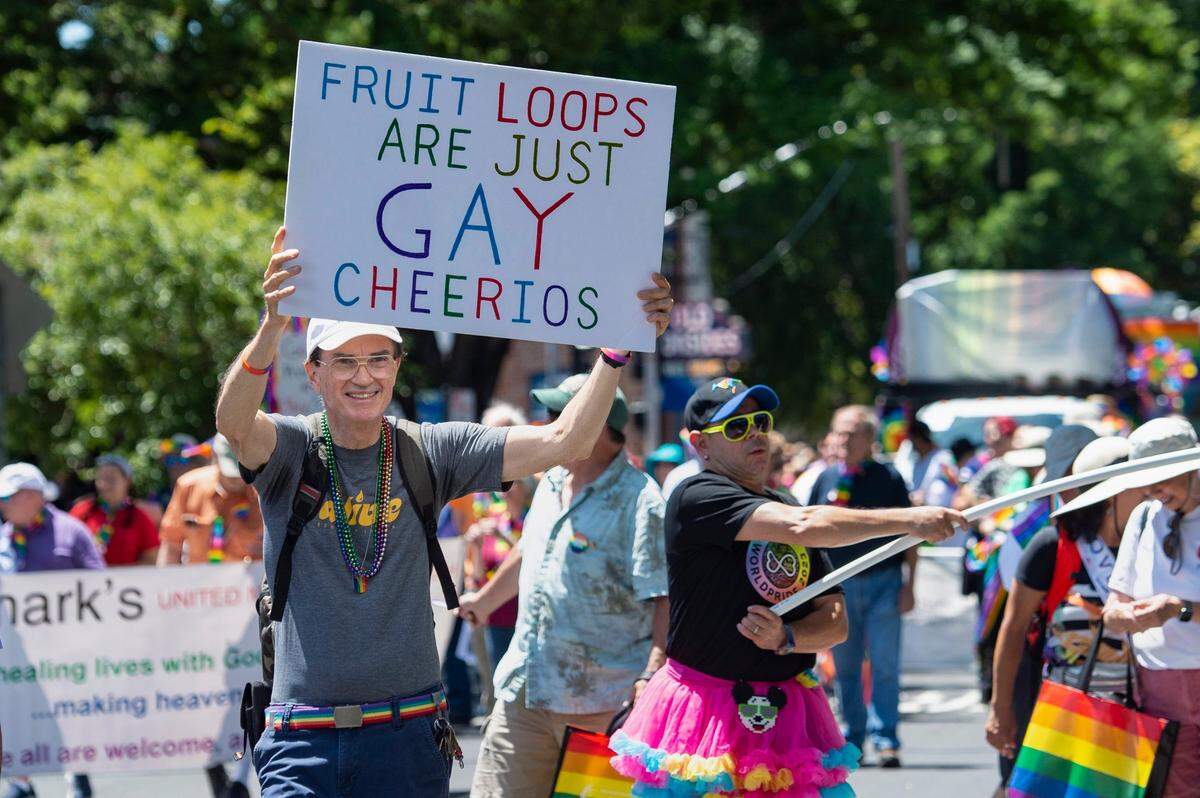 Evan Phillips, of the First United Methodist Church, holds a sign “Fruit Loops are just Gay Cheerios” during the Sacramento Pride March and Parade on Sunday, June 11, 2023, in Sacramento.