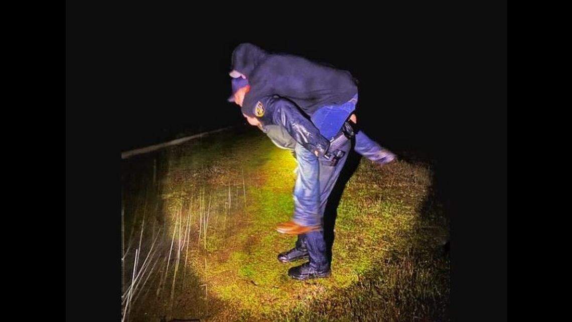 A California Highway Patrol officer carries a man who was lost and hurt to safety near Oroville at 3 a.m. Tuesday, the agency says.