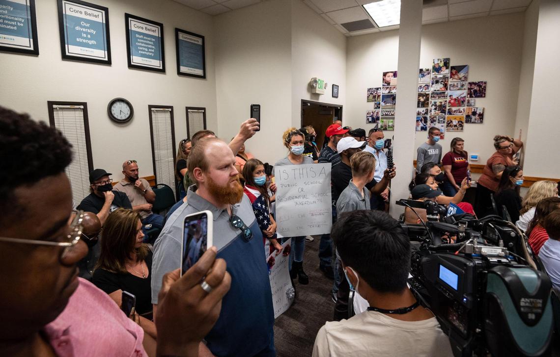 Chris Orr, center, waits to speak as parents and other interested people direct outrage at the Natomas Unified School District board members during a meeting Wednesday, Sept.1, 2021, at the district headquarters in Natomas. An Inderkum High School AP Government teacher was shown in a video released by Project Veritas, a conservative activist group that often produces undercover videos, discussing antifa and saying he wanted his students to become “revolutionaries.”