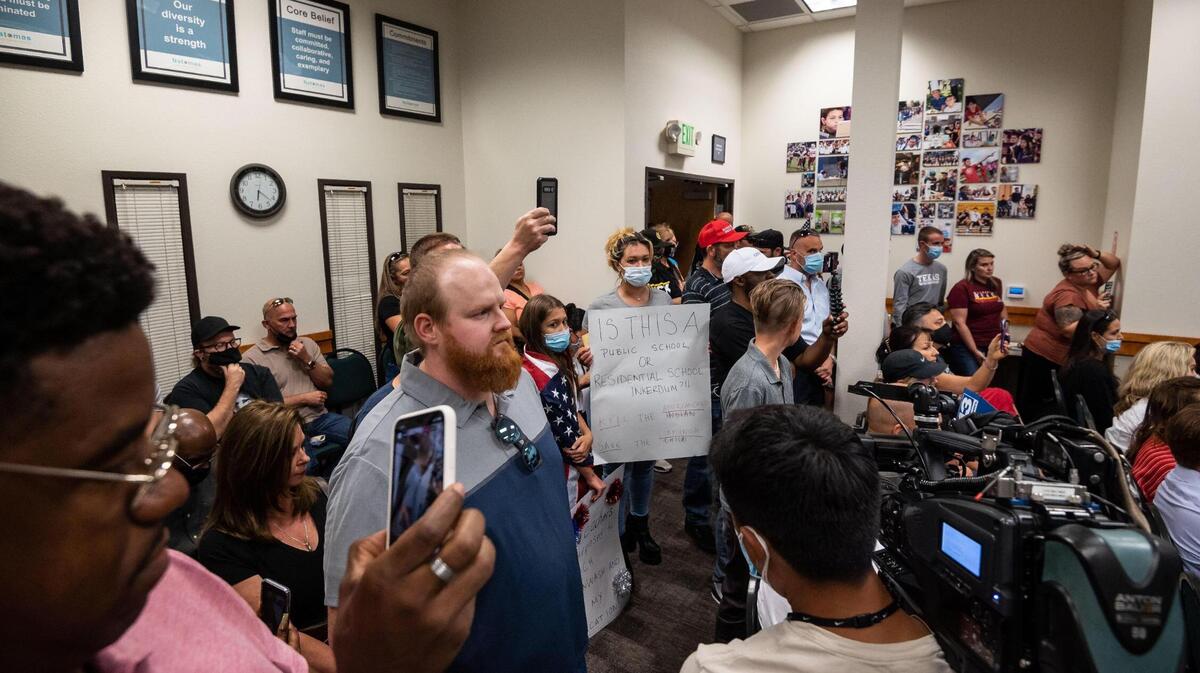 Chris Orr, center, waits to speak as parents and other interested people direct outrage at the Natomas Unified School District board members during a meeting Wednesday, Sept.1, 2021, at the district headquarters in Natomas. An Inderkum High School AP Government teacher was shown in a video released by Project Veritas, a conservative activist group that often produces undercover videos, discussing antifa and saying he wanted his students to become “revolutionaries.”