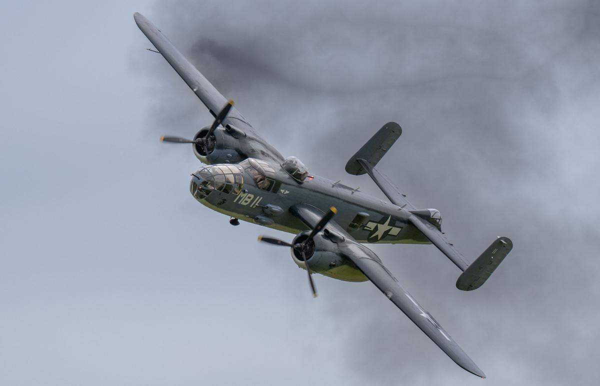 A World War II North American B-25 Mitchell flies through smoke from pyrotechnics at the California Capital Airshow at Mather Airport on Saturday, March 22, 2025.