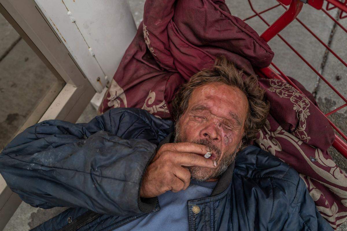 Mark Rippee rests on the side of a bus stop after urinating outside in Vacaville on Aug. 1. “I would like to see my brother receive treatment for the no fault brain disease that he has. I would like to see him have safe housing. He just needs someone to care for him,” said his sister Linda Privatte.